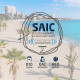Logotipo de SAIC sobre imagen de playa de la Albufereta de Alicante